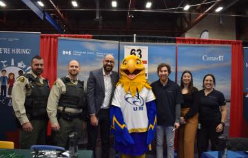 Group posing for a photo at a career fair